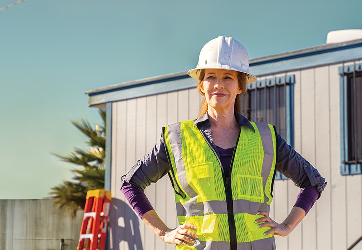 Woman wearing hard hat on construction site